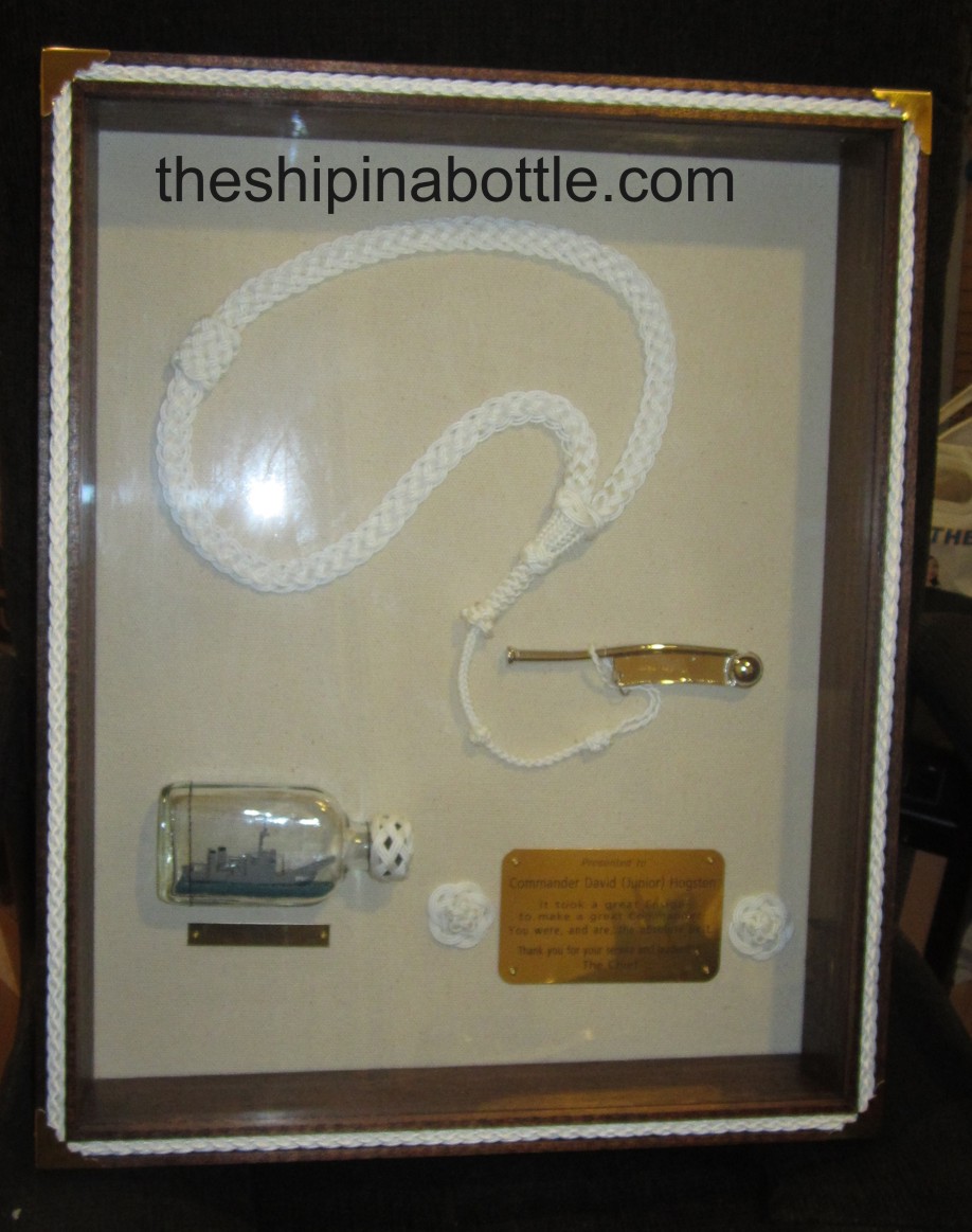 Cased ship in bottle, pipe and lanyard, engraving.